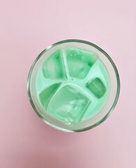 Mint with milk ice on pink background