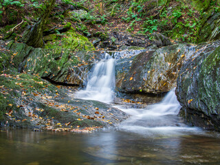 Fototapeta na wymiar Waterfall with silky, smooth water in the Adirondack Mountains, Upstate New York, USA.