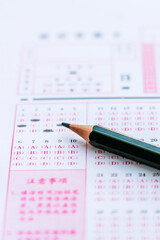 Exam answer sheet and a pencil