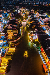 Obraz premium Aerial photography of night view of pleasure boats shuttling on the Qinhuai River in Nanjing, Jiangsu, China
