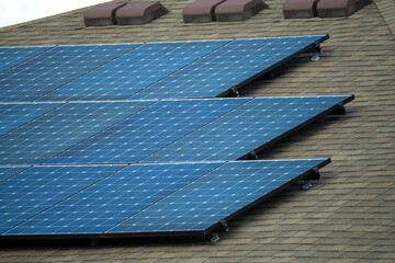 Aerial view of typical american building roof with blue solar photovoltaic panels for producing...