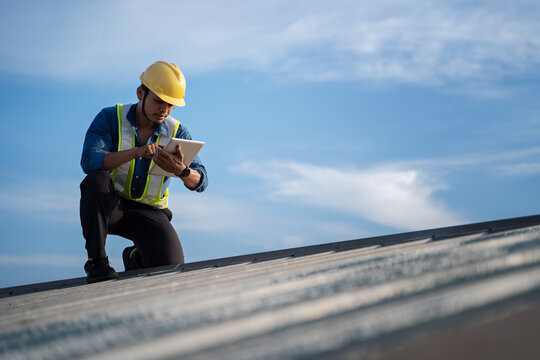 Engineer using tablet to inspect work at job site. concept of technology usage In industrial applications, remote data retrieval, large databases. network link. - Powered by Adobe
