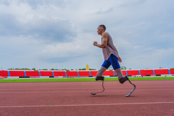 Dedicated Asian speed runner, equipped with two prosthetic running blades, jogging steadily on the running track at the local sports stadium - Powered by Adobe