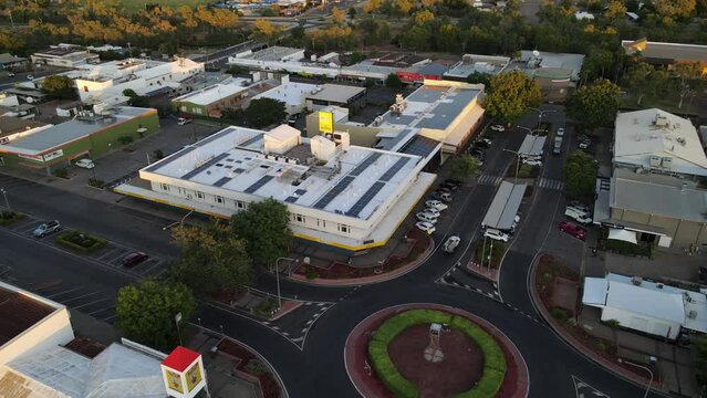 Drone aerial of Mount Isa town square round about during sunrise parallax