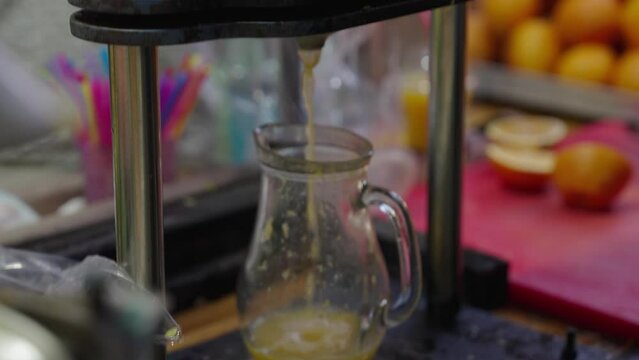 Orange squeezed in manual press to make fresh juice, Nazareth market