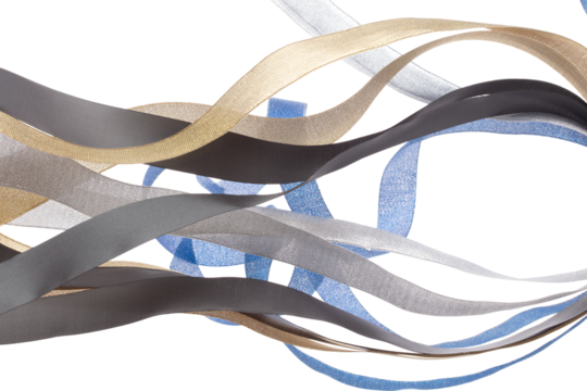 Colorful ribbon long straight fly in air with curve roll shiny. Blue silver gold black ribbon for present gift birthday party to wrap around decorate, blow fly in wind. White background isolated