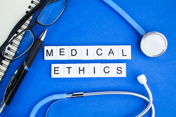 stethoscope, pen and glasses with the word Medical Ethics. concept of medical ethics 