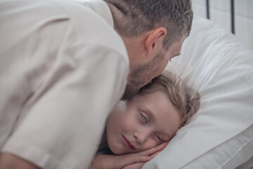 Obraz na płótnie Canvas Father singing his daughter to sleep, providing comfort, support, and security. Focusing on fulfilling both physical and emotional needs. Kids sometimes act happy while pretending to fall asleep.