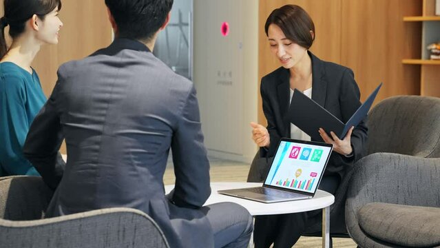 A middle-aged couple and a counselor having a conversation in the lobby. Financial planner. Advisor.