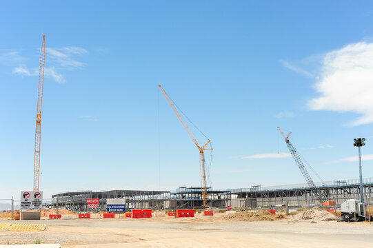 Wide view of the Meta Mesa Data Center five-building campus under construction with multiple cranes, steel framework, and site barriers, illustrating large-scale tech infrastructure development