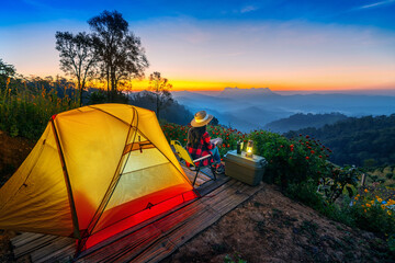 Tourist relaxing while camping at sunrise. Doi Luang Chiang Dao mountains in Chiang Mai.