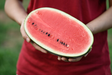 Half watermelon fruit holding by woman hand in summer season, Tropical fruit