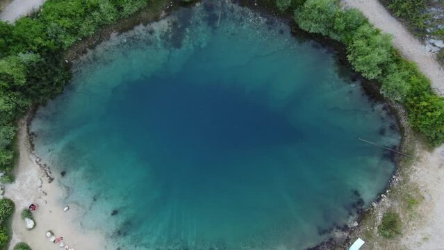 People having a Picnic at Cetina River Spring (Izvor Cetine), also known as Eye Of The Earth, a karst spring at the foothills of Dinara mountains, Croatia. Aerial