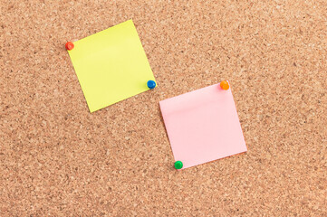 multi-colored memory papers pinned on a cork board.