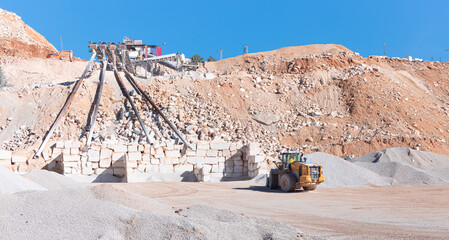 Industrial stone production, Crushed stone mining plant - Heavy and mobile machinery in a quarry to transform stone into construction material