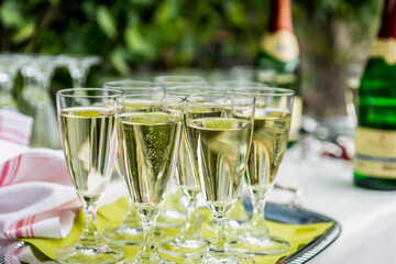 sparkling wine in glasses in restaurant or on a party wedding dinner setting