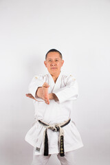 studio photograph of a karateka on a light background. concept of sports and healthy life.