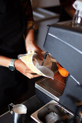 Barista cleaning the machine after used