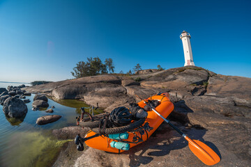 Fototapeta premium A man with a bicycle in a boat near the sea lighthouse