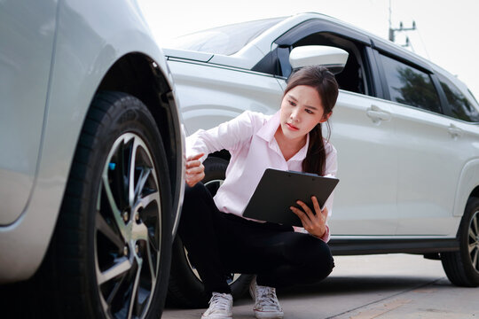 Young Beautiful Woman Car Insurance Company Representative Holding Car Accident Claim Procedure Form. Transport Concept. Traffic Accident And Insurance.