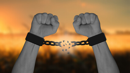 Two arms with clenched fists break the chains, with a blurred warm sunset in the background