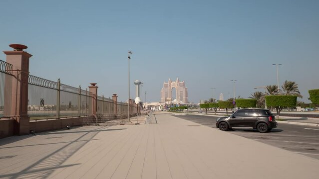sunny day abu dhabi city modern famous hotel traffic bay walking pov panorama 4k timelapse uae