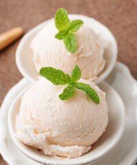 Appetizing coconut homemade scoop decorated with and served in bowl