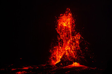 Lava erupting. Night view of Halemaʻumaʻu from Kilauea Overlook  June 2023. Kīlauea Caldera. Hawaiʻi Volcanoes National Park.

