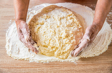 Preparation doughs. Preparation doughs women's hands. Making dough by male hands at bakery. Food concept. Hands dough. Female hands making dough for pizza. Chef in professional kitchen prepares dough