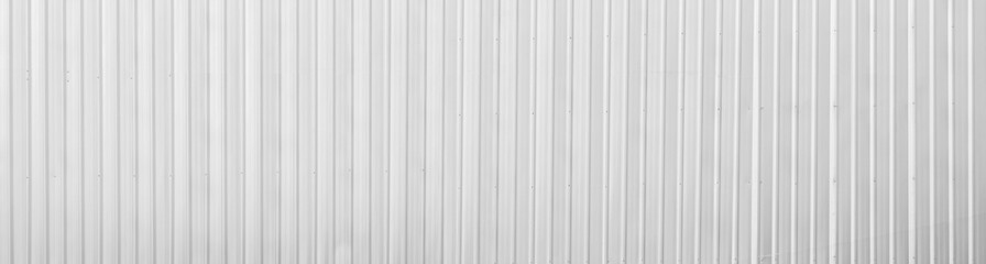 Fototapeta premium Wide metal aluminum silver corrugated stripe sheet wall background with texture vertical lines