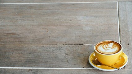 A cup of coffee on wooden table. 