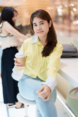 young woman drinking coffee, female hand holding and enjoying a cup of tea at cafe shop