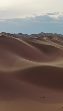 Aerial view of the sand dunes Hongoryn Els in Gobi Desert, Mongolia. Vertical video