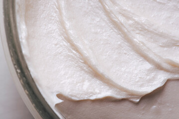 Background with texture of pearl cream in a jar.