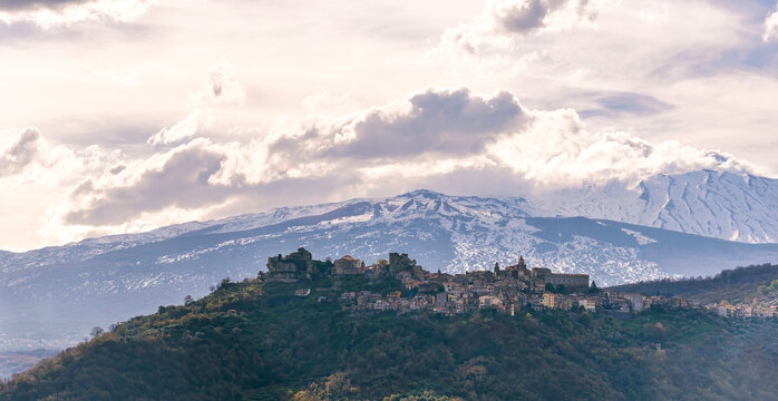 amazing mountain travel landscape of view on highland town with top mountains with snow and beautiful cloudy sunset on dackground