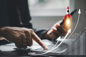 A white rocket icon soaring into the sky from a laptop computer, signifying a startup's success and...