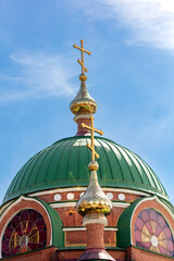 Fototapeta na wymiar Bell tower of the Russian Orthodox Church against the blue sky