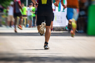 Male runner in sports gear at the finish line