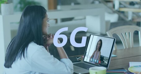 Animation of 6g text banner against biracial woman having a video call on laptop - Powered by Adobe