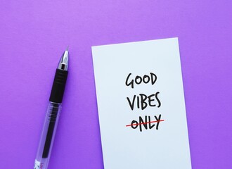 Note on purple background with handwritten text GOOD VIBES ONLY, crossed off ONLY avoid toxic...