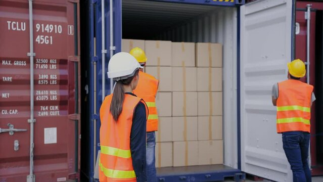 Manager engineer woman control work via Walkie talkie while foreman and a worker help opening containers together at the transport warehouse. Cargo container and Transport Logistic concept