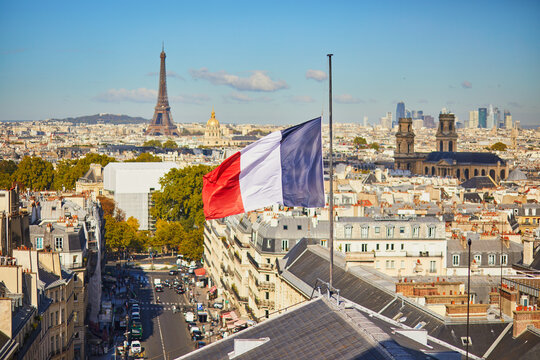 Aerial view of the Eiffel tower over the French flag in Paris, France - Powered by Adobe