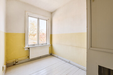 an empty room with yellow paint on the walls and white wood flooring in front of a window that is open