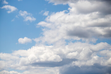 Naklejka na ściany i meble White cumulus clouds against the blue sky