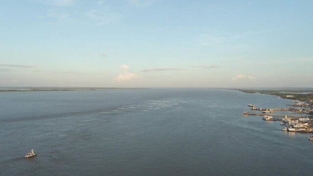 View of Port of Santarem at golden hour, Para, Brazil. Aerial pan right