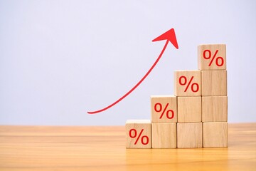 Up arrow from wooden block elements with percent sign concept of economy.