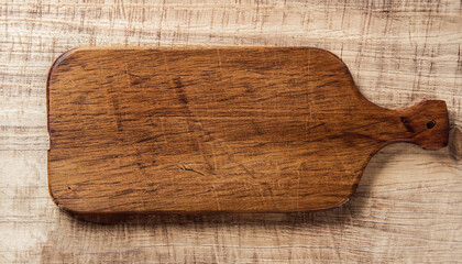 Empty vintage cutting board on planks food background concept