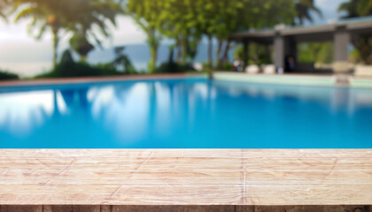 Fototapeta na wymiar Empty white marble stone table top and blurred swimming pool in tropical resort in summer banner background - can used for display or montage your products.