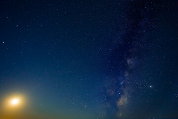 Fototapeta na wymiar night starry sky with milky way and rising moon