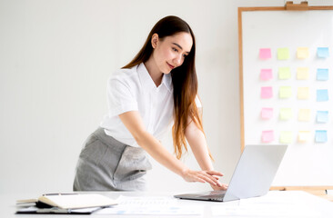 Asian businesswoman calculate financial graphs showing results about their investments and planning...